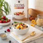 "A bowl of gluten-free rice cereal topped with fresh fruits and nuts, with a box of gluten-free rice cereal on a breakfast table."